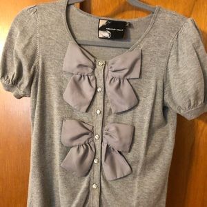 Cute sweater knit top with bow detail.